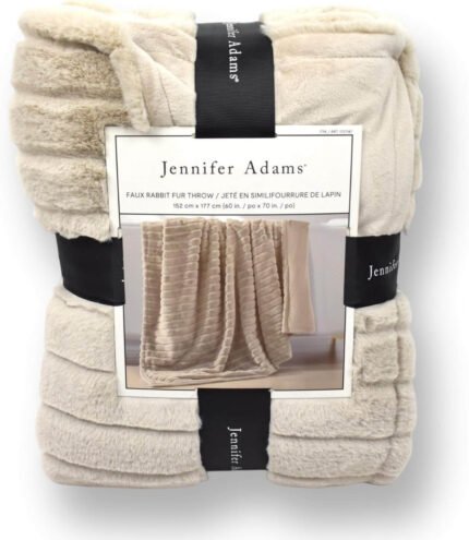 Jennifer Adams Faux Rabbit Fur Throw Blanket in Light Tan, draped over a couch, showcasing its velvety soft texture and elegant neutral tone.